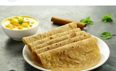 a plate of food with waffles and a bowl of soup at Stains holidayhome & party floor, Cherai beach in Pallipuram