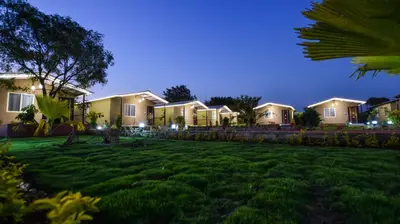 a row of houses in a yard at night at Valley Vibes in Rāmanagaram