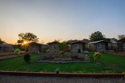 a yard of houses with a garden in the sunset at Valley Vibes in Rāmanagaram