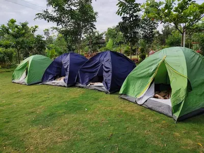 a group of three tents in a field at Valley Vibes in Rāmanagaram