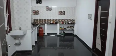 a bathroom with a sink and a toilet in a room at Hotel Rams in Coimbatore