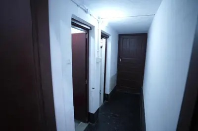 an empty hallway with two doors and a hallway at Koodapuzha House Chalakudy in Kizhake Chālakudi