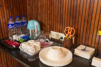 a counter with a table with bottles of water at Sancta Maria Airport Suites in Nedumbassery