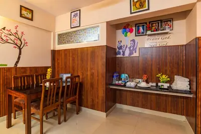 a restaurant with a table and chairs in a room at Sancta Maria Airport Suites in Nedumbassery