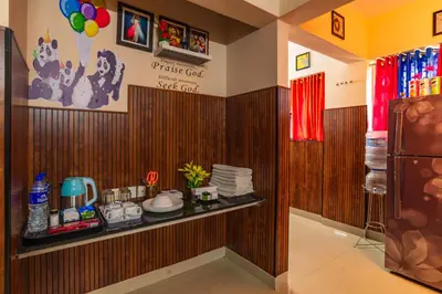 a room with a shelf with dishes on it at Sancta Maria Airport Suites in Nedumbassery