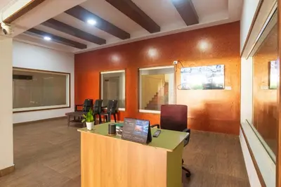 an office with a desk and chairs in a room at Sancta Maria Airport Suites in Nedumbassery