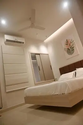 a bedroom with a bed and a mirror at K.K RESIDENCY in Palakkad