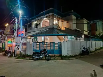 a motorcycle parked in front of a building at night at K.K RESIDENCY in Palakkad