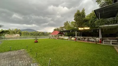 a building with a green lawn in front of it at River View Apartments a Pet Friendly Retreat in Ernakulam