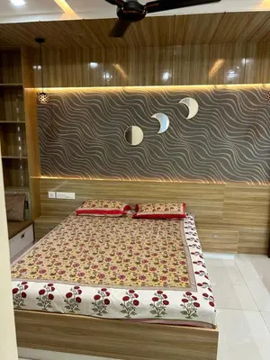 a bed with two pillows on it in a bedroom at Thottan house in Trichūr