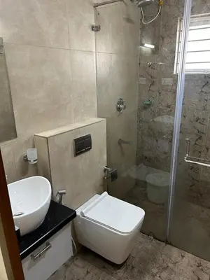 a bathroom with a toilet sink and a shower at Thottan house in Trichūr
