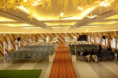 a large room with chairs and people sitting in it at Jayalakshmi Residency in Vaduvanchal