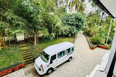 a white van parked in a driveway with a slide at Exuberance Villa in Batheri