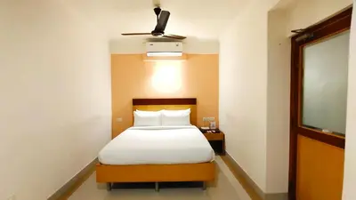 a bedroom with a bed and a ceiling fan at Hyson heritage calicut in Kozhikode