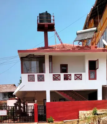 a building with an observatory on top of it at Holidayincoorg - Brick lane in Madikeri