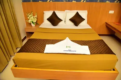 a hotel room with a bed with a sign on it at Rajalakshmi Comforts Mysuru in Mysore