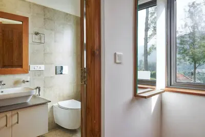 a bathroom with a toilet and a sink and a window at Shangrila Casa-Premium Homestay in Wellington Town