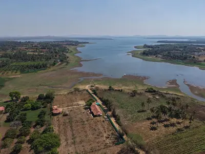an aerial view of a river and a house at Trogon resort in Kabini River