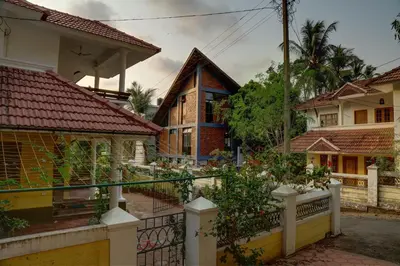 a house with a fence in front of it at Vettaths in Kozhikode