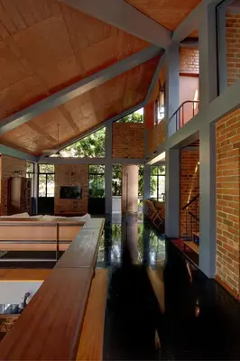 a living room with a wooden bench in a house at Vettaths in Kozhikode