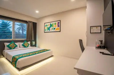 a bedroom with a bed and a desk at Treebo Sanmaya Retreat, 15 Mins From Mysore Palace in Mysore