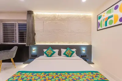 a bedroom with a large bed and a window at Treebo Sanmaya Retreat, 15 Mins From Mysore Palace in Mysore