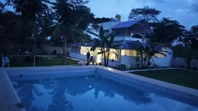 a villa with a swimming pool at night at Suggi Farm House in Halgūr