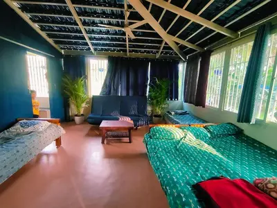 a large room with two beds and a couch at Suggi Farm House in Halgūr
