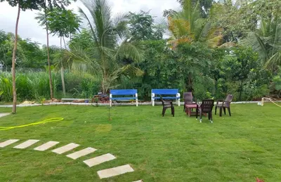 a group of chairs and tables in a yard at Suggi Farm House in Halgūr