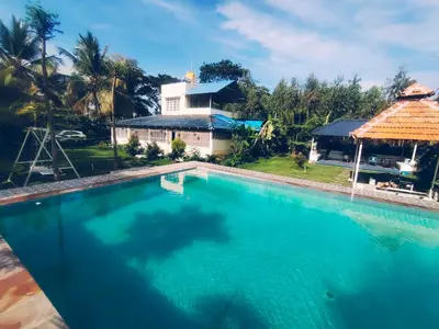 an overhead view of a swimming pool in front of a house at Suggi Farm House in Halgūr