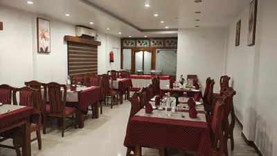 a dining room with tables and chairs in a restaurant at City Palace Residency Nilambur in Wandūr