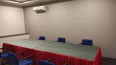 a conference room with a table with chairs and a heater at City Palace Residency Nilambur in Wandūr