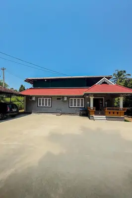 a large parking lot in front of a building at Evergreen Homestay in Kollengode