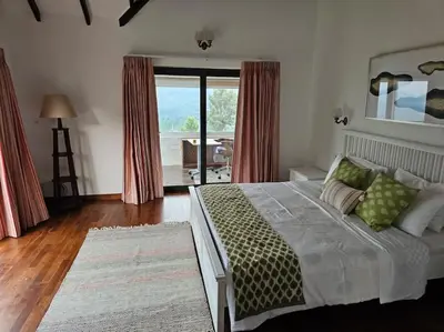 a bedroom with a large bed and a balcony at Shangrila Casa-Premium Homestay in Lovedale