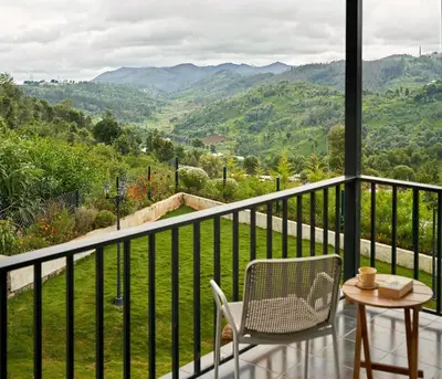 a balcony with a table and chairs and a view at Shangrila Casa-Premium Homestay in Lovedale