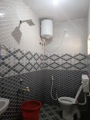 a bathroom with a toilet and a sink at Harvest Hill View Cottage in Ooty