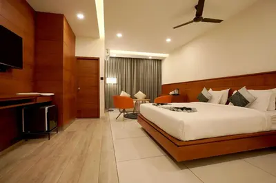 a hotel room with a bed and a television at Stayon Hotels in Palakkad