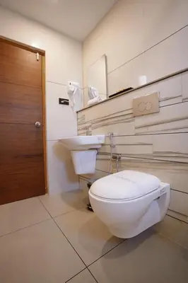 a bathroom with a toilet and a sink at Stayon Hotels in Palakkad