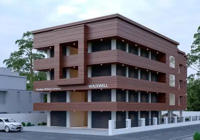 a brown building with a car parked in front of it at Stayon Hotels in Palakkad
