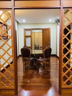 a dining room with a table and chairs and wine racks at Yemcee Rivera in Tellicherry