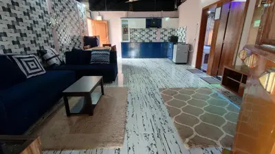 a living room with a couch and a table at Encanto Farmstay Resort in Mysore