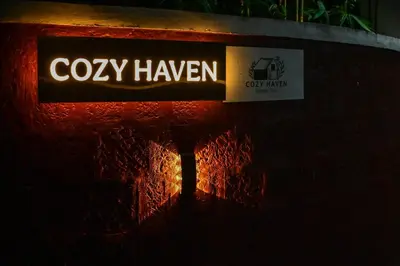 a sign for a coty hawken on the side of a building at Cozy Haven Homestay in Meenangadi
