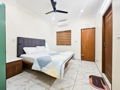 a bedroom with a bed and a ceiling fan at Nutmeg Farmstay with Pool, Vadakkencherry, Palakkad in Vadakkāncheri