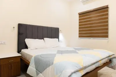 a bedroom with a large bed and a window at Nutmeg Farmstay with Pool, Vadakkencherry, Palakkad in Vadakkāncheri
