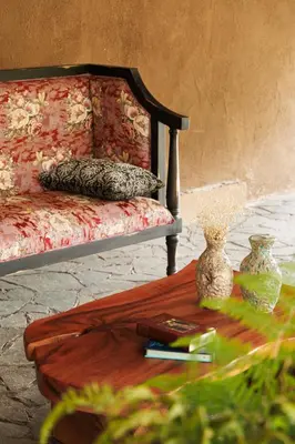 a room with a bed with a table and vases on it at Jungle Park Resort-Rain Forest Experience by GreenEscapes in Vythiri