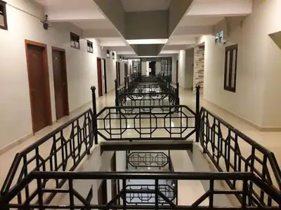 an empty hallway with a row of metal benches at PLAZA RESIDENCY and CONFERENCE HALL in Malappuram