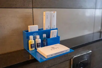 a blue tray with bottles of alcohol on a counter at Mazarine Hotels & Resorts LLP in Kalpetta
