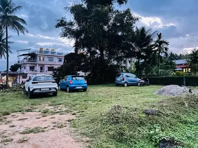 a group of cars parked in front of a house at GURI Homestay in Kushālnagar