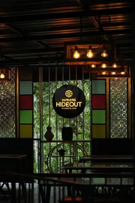 a restaurant with a sign that reads sd inside theoitoitoitoit at Hunters Hideout Resort in Wayanad