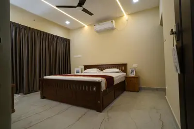 a bedroom with a bed and a ceiling fan at Elephant Village Private Pool Villa in Munnar